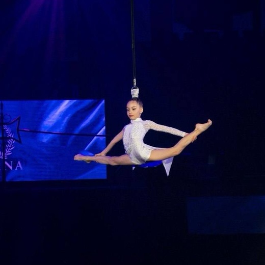 Infinity Artist aerial performance in white costume